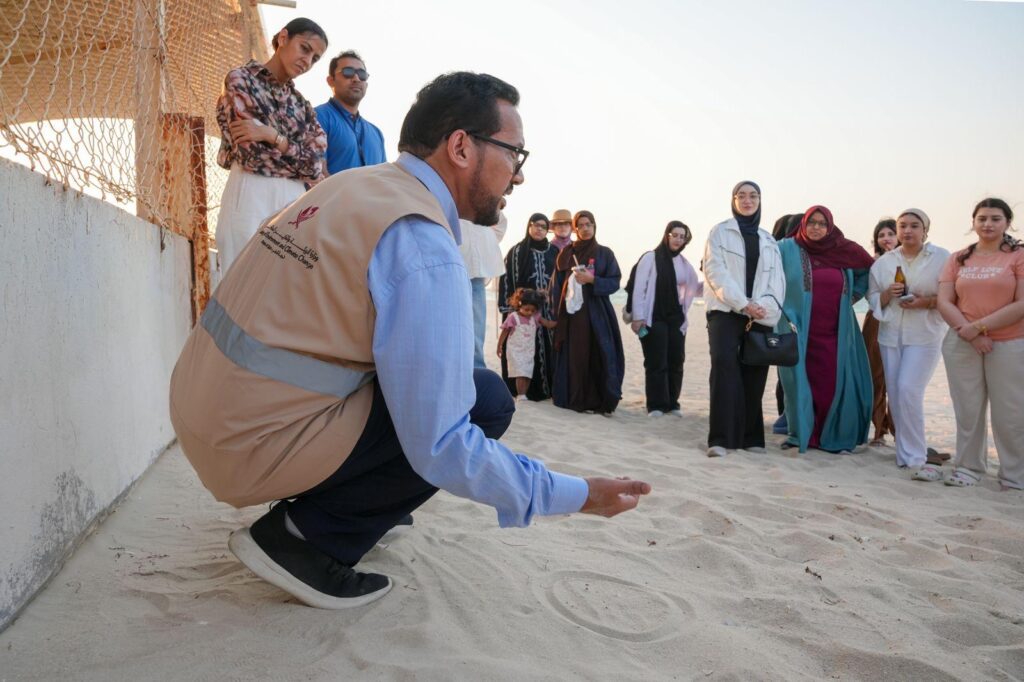 Barzan University College students receive a conservation briefing before participating in a Hawksbill sea turtle protection experience at Fuwairit Beach, Qatar.